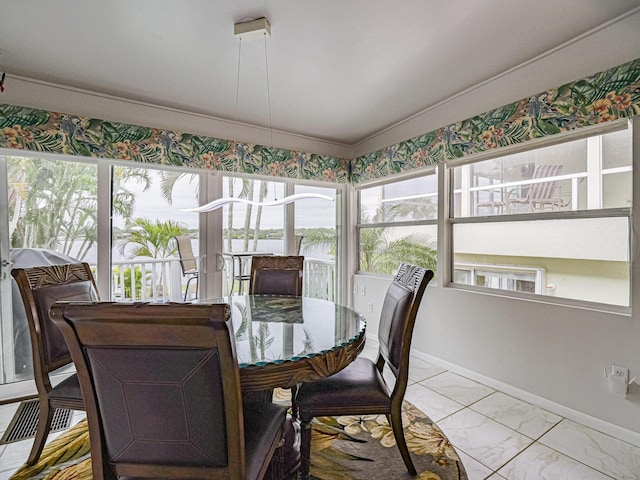 sunroom featuring vaulted ceiling and visible vents