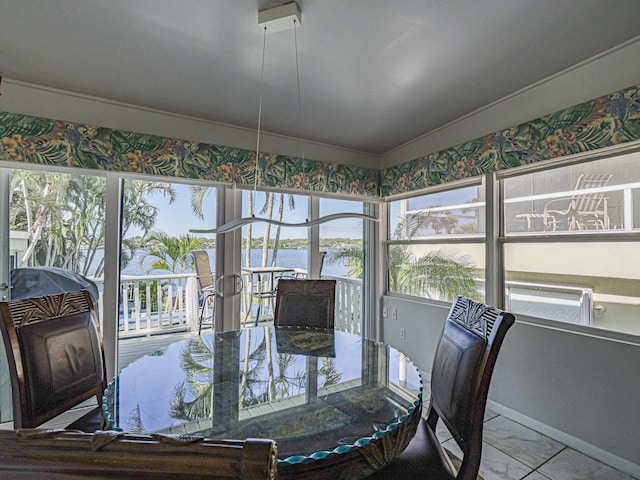 sunroom / solarium with a water view