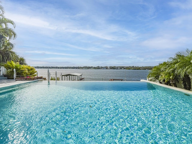 view of swimming pool featuring a water view