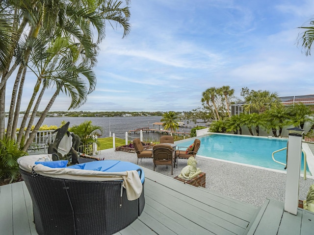 outdoor pool with a deck with water view