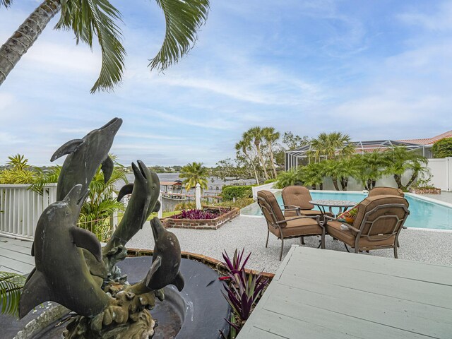 view of pool with a water view and a patio area