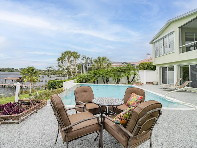 view of pool featuring a patio, a water view, a fenced backyard, and a fenced in pool