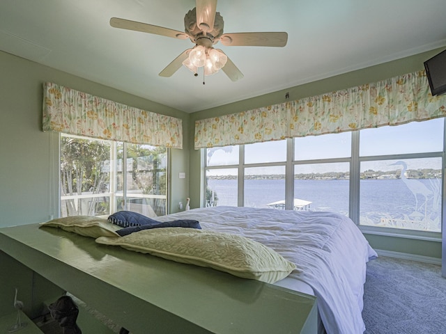 carpeted bedroom with a ceiling fan and baseboards