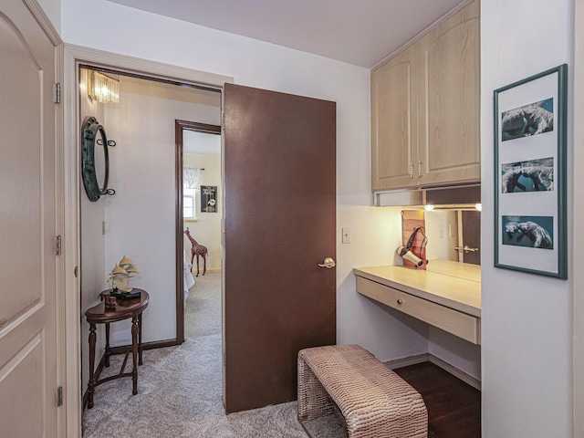 corridor featuring carpet floors and baseboards