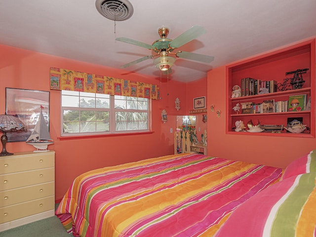 carpeted bedroom with a ceiling fan and visible vents