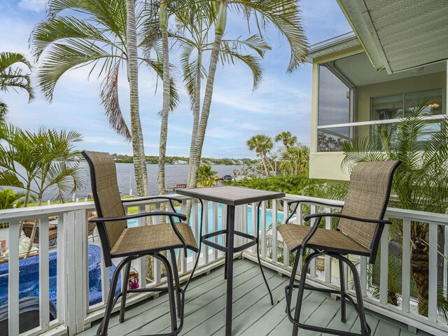 view of swimming pool with a hot tub and a water view