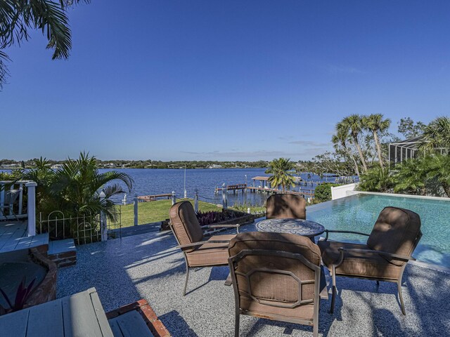 exterior space with a water view and a hot tub