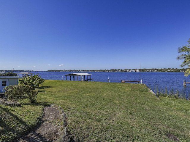 exterior space featuring a water view and a yard