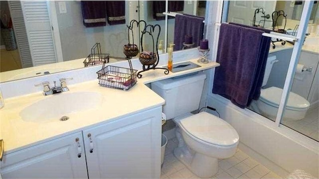 full bathroom featuring enclosed tub / shower combo, vanity, toilet, and tile patterned flooring