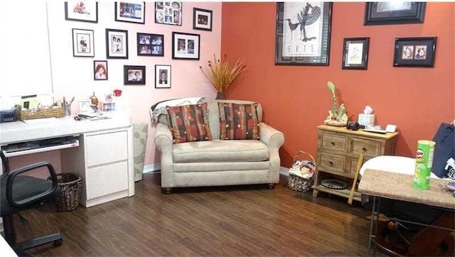 sitting room with dark wood-type flooring