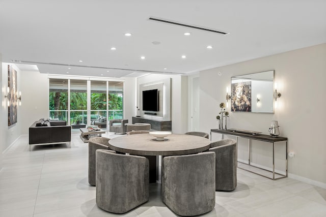 tiled dining room featuring a wall of windows