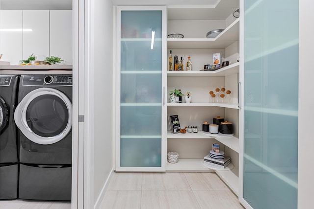 clothes washing area featuring washer and clothes dryer