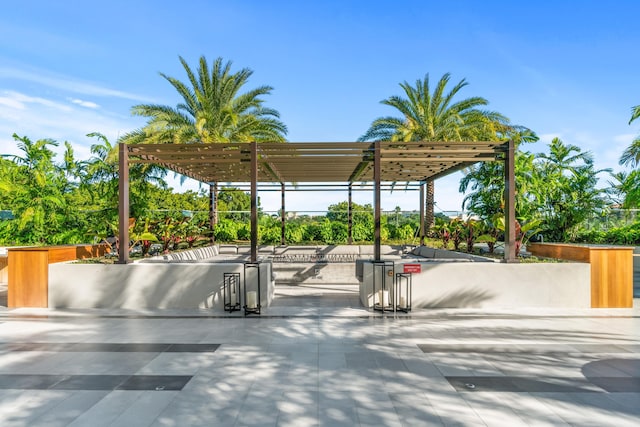 view of community featuring a patio and a pergola