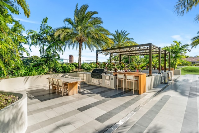 view of patio / terrace featuring a bar, area for grilling, and a pergola