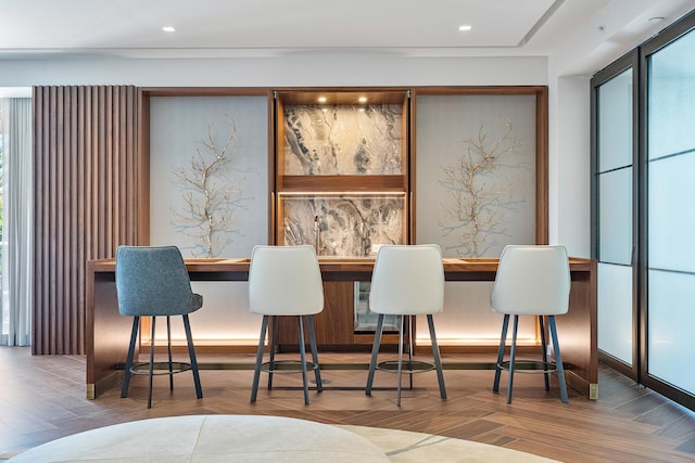 dining area with parquet flooring and bar