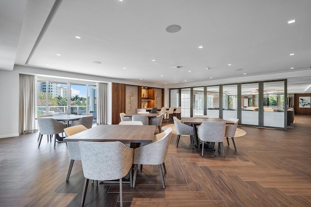 dining space featuring dark parquet flooring