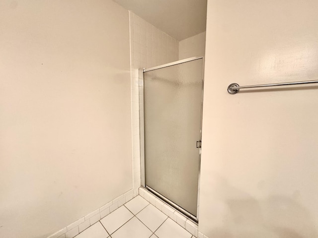 bathroom featuring walk in shower and tile patterned floors