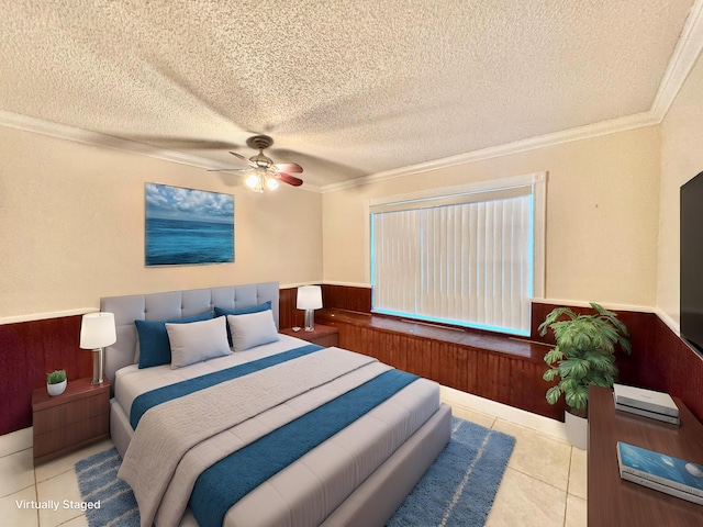 tiled bedroom featuring crown molding, wooden walls, a textured ceiling, and ceiling fan