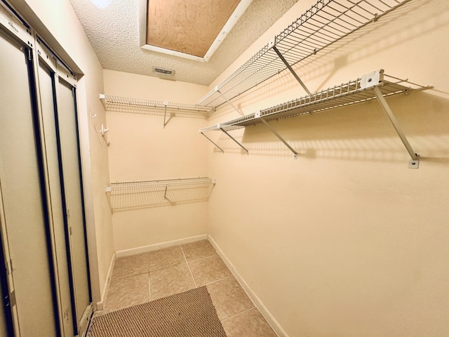 walk in closet featuring light tile patterned floors