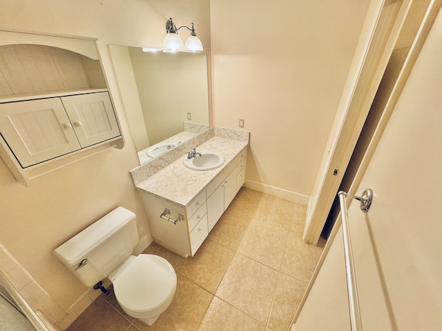 bathroom with vanity, tile patterned flooring, and toilet