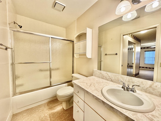 full bathroom with bath / shower combo with glass door, vanity, and toilet