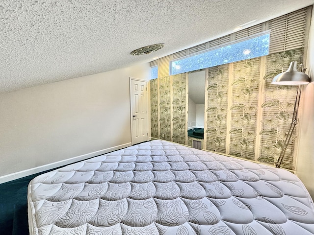 unfurnished bedroom with carpet and a textured ceiling