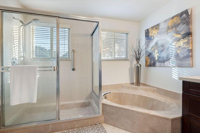 bathroom with vanity, a healthy amount of sunlight, tile patterned floors, and plus walk in shower