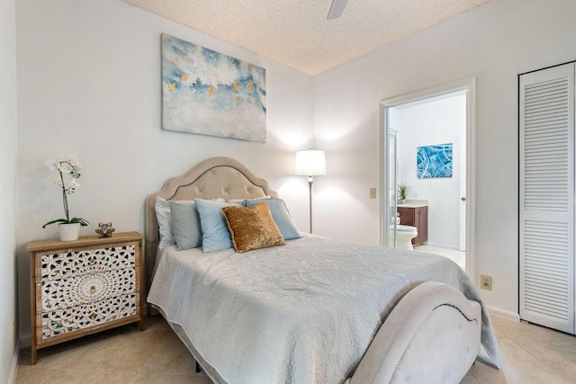 tiled bedroom with ceiling fan, a textured ceiling, and a closet