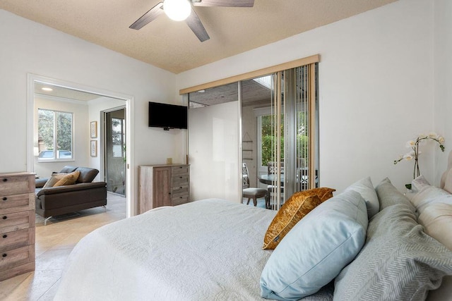 tiled bedroom featuring ceiling fan, access to exterior, and multiple windows