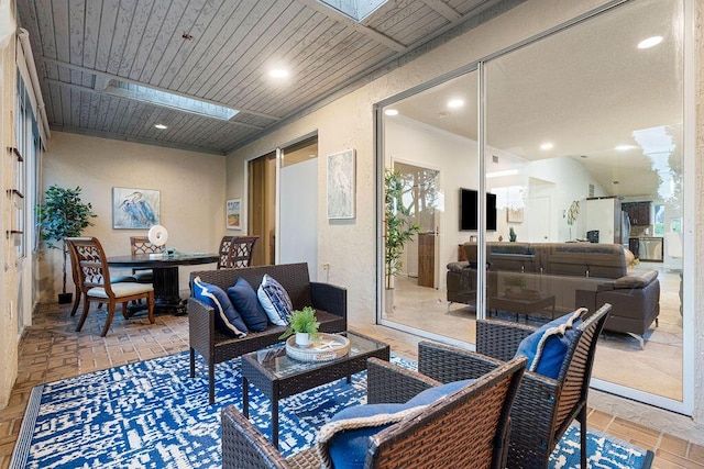 living room featuring ornamental molding and wood ceiling