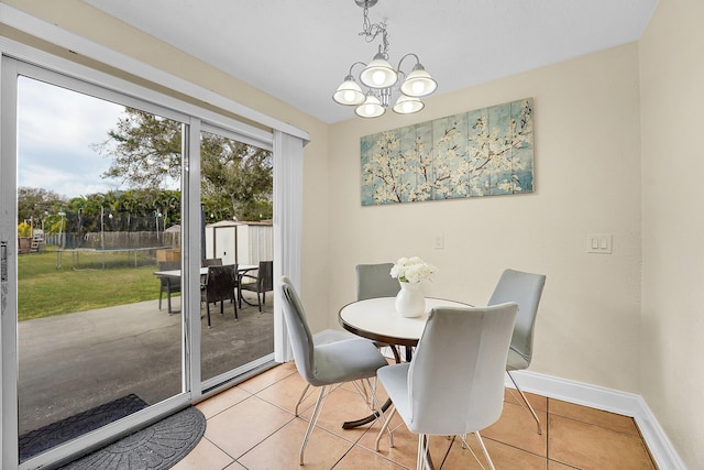 tiled dining space with a notable chandelier