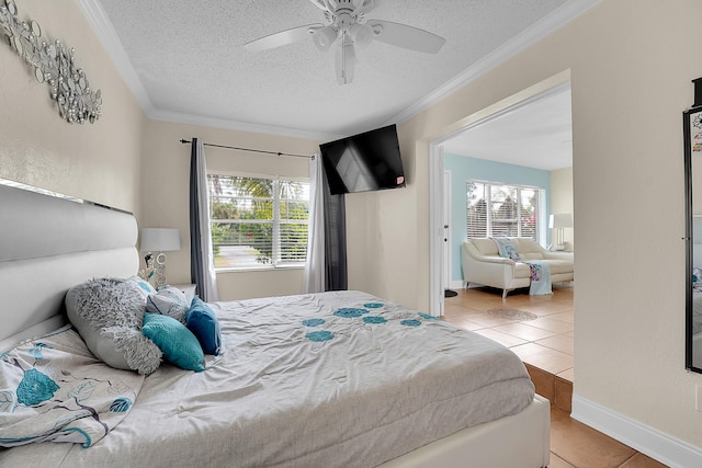 tiled bedroom featuring ceiling fan, a textured ceiling, and crown molding