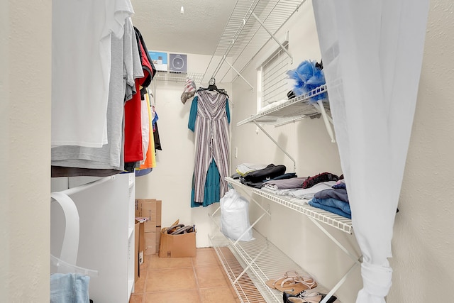 spacious closet with light tile patterned floors