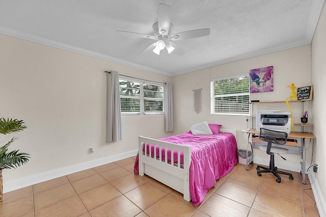 bedroom with ceiling fan, a textured ceiling, tile patterned floors, and ornamental molding