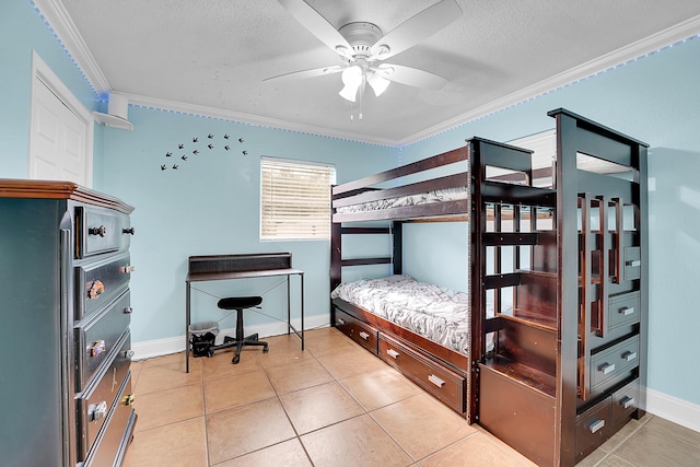 tiled bedroom with a textured ceiling, ceiling fan, and crown molding