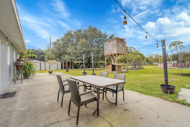 view of patio / terrace featuring a storage shed and a trampoline