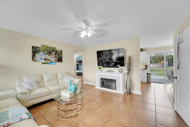 tiled living room with ceiling fan