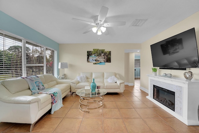 tiled living room featuring ceiling fan