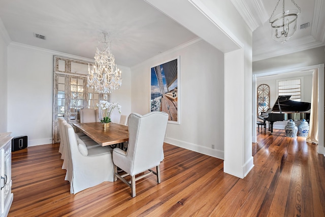 dining room with hardwood / wood-style flooring, a chandelier, and ornamental molding