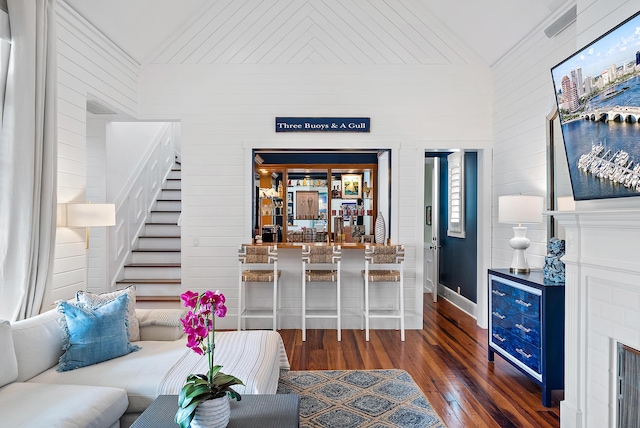 living room with lofted ceiling and dark wood-type flooring