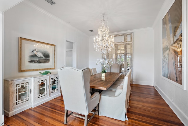 dining room featuring crown molding, dark wood-type flooring, and an inviting chandelier