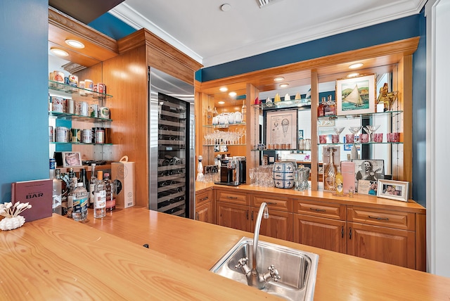 bar featuring wine cooler, sink, and ornamental molding