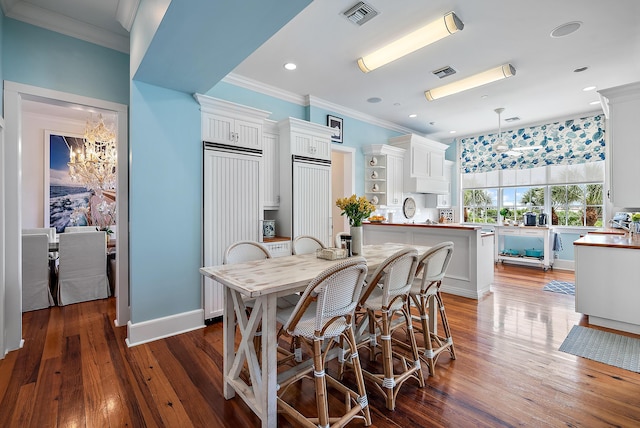 kitchen featuring pendant lighting, white cabinetry, dark hardwood / wood-style floors, and a center island