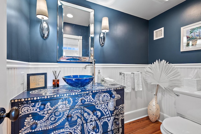 bathroom with vanity, hardwood / wood-style flooring, and toilet