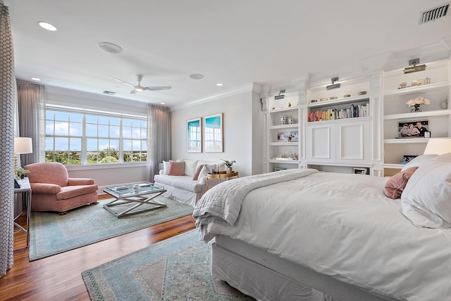 bedroom with hardwood / wood-style flooring, ceiling fan, and crown molding