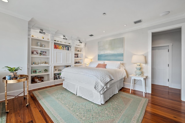 bedroom with ornamental molding and dark hardwood / wood-style flooring