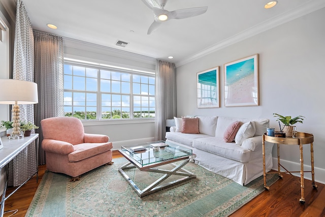 living room featuring dark hardwood / wood-style flooring, ornamental molding, and ceiling fan