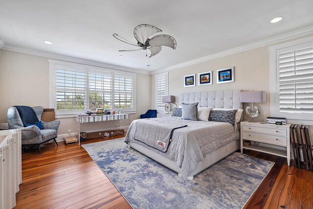 bedroom with crown molding, hardwood / wood-style floors, and ceiling fan