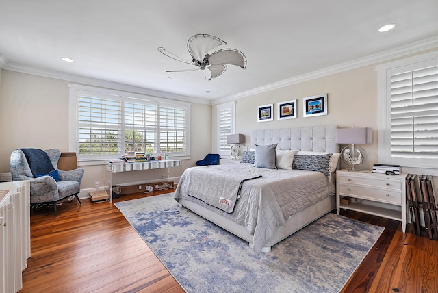 bedroom with dark wood-type flooring, ceiling fan, and ornamental molding