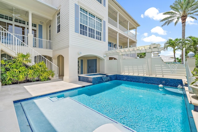 view of pool with an in ground hot tub